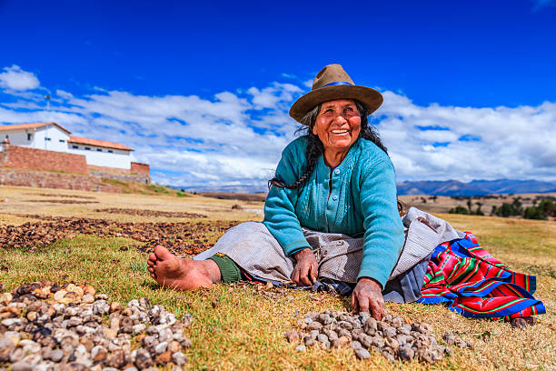 Old woman on the floor with potatoes